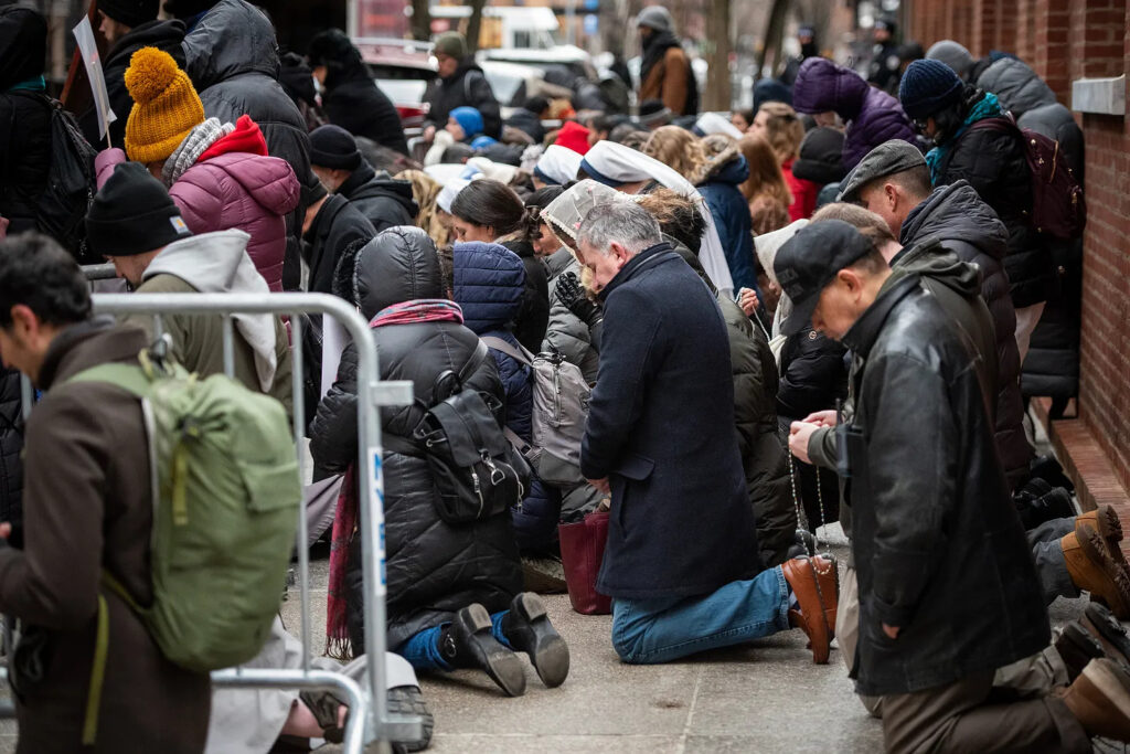 Participants kneel in prayer outside the Planned Parenthood facility at 26 Bleecker Street in Lower Manhattan during the monthly Witness for Life prayer vigil in February 2025.