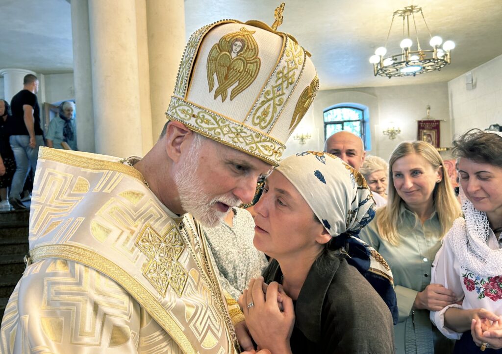 A woman speaks with Metropolitan Archbishop A. Gudziak of the Ukrainian Greek Catholic Archeparchy of Philadelphia September 8, 2024, following Divine Liturgy at St. Nicholas the Wonderworker Ukrainian Greek Catholic Church in Kharkiv, Ukraine.
