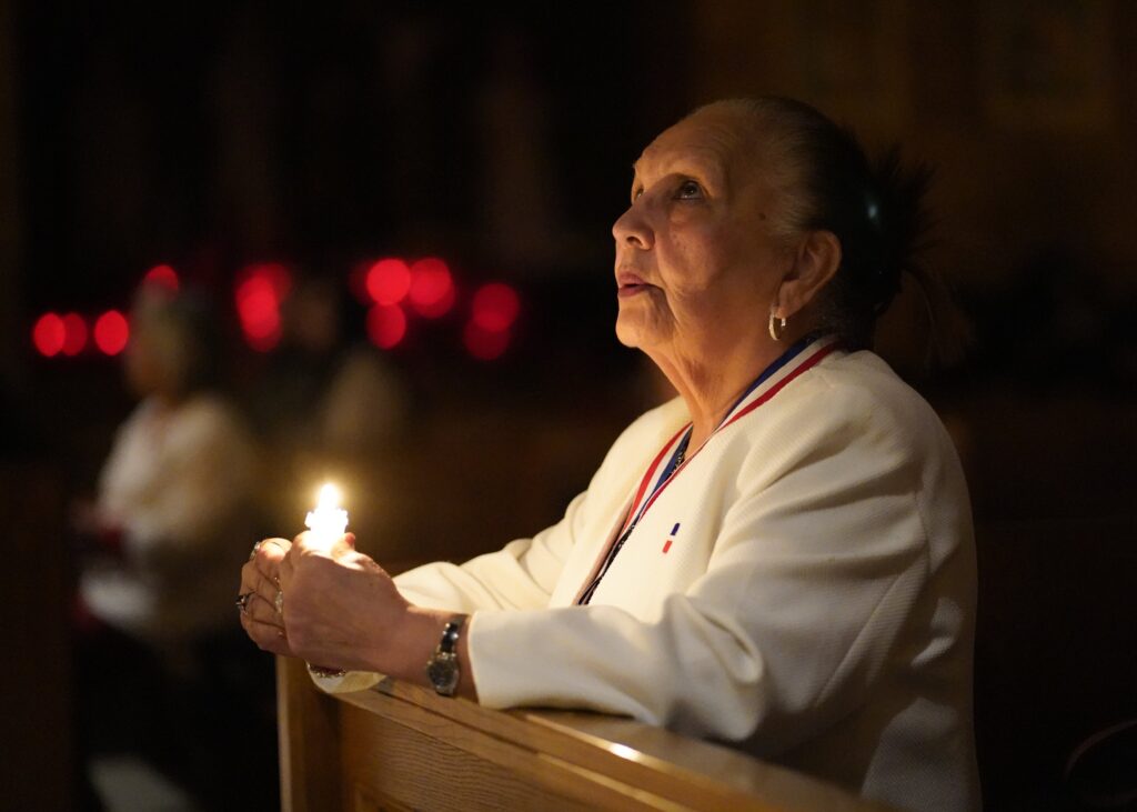 A woman prays during a Spanish-language candlelit Mass celebrated on the eve of the feast of the Presentation of the Lord, also known as Candlemas, at St. Joseph Church in Staten Island on February 1, 2025.