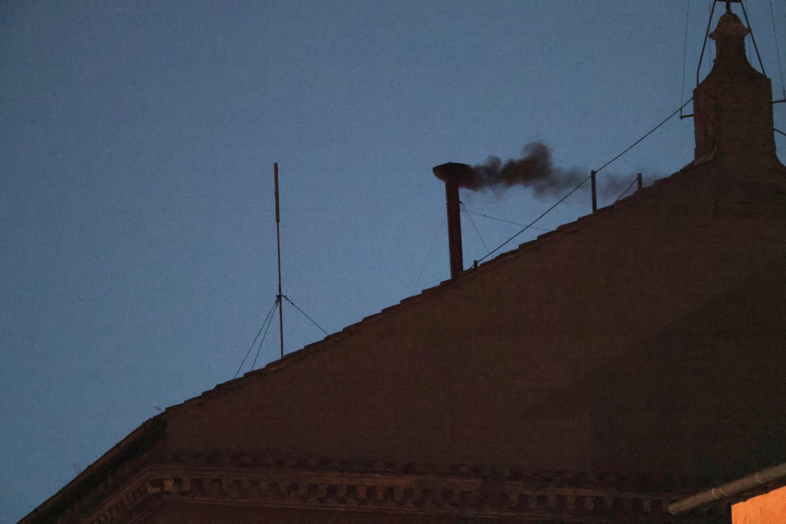 Black smoke billows from the chimney of the Sistine Chapel on May 7, 2025, on the first day of the conclave.