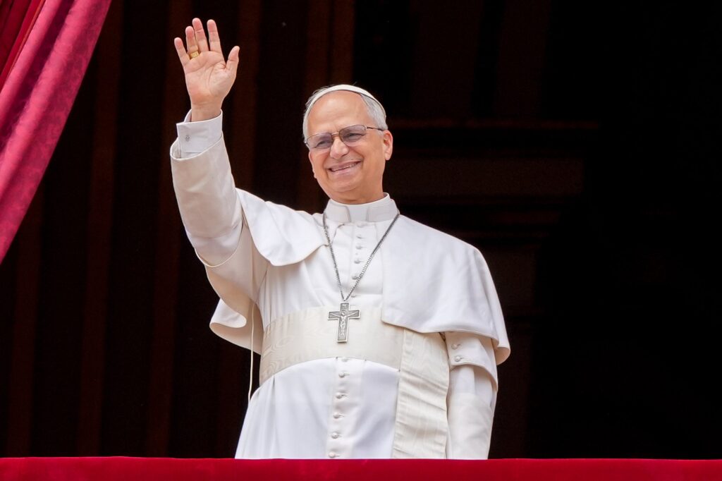 Pope Leo XIV waves to the crowd from the central balcony of St. Peter's Basilica at the Vatican as he leads, for the first time, the midday recitation of the "Regina Coeli" prayer May 11, 2025.