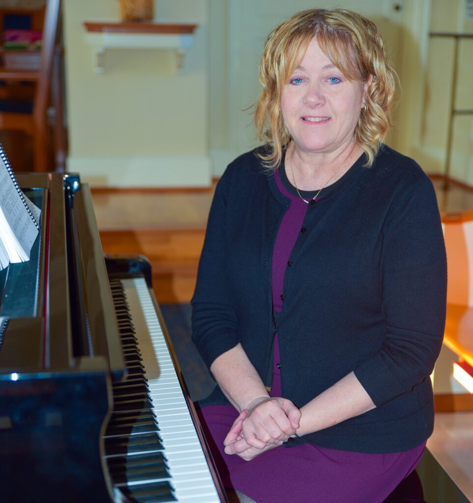 Kimberly Hess, an organist at Arlington National Cemetery in Virginia, poses for a photo in October 2024 in Sacred Heart of Mary Chapel at Marymount University in Arlington.