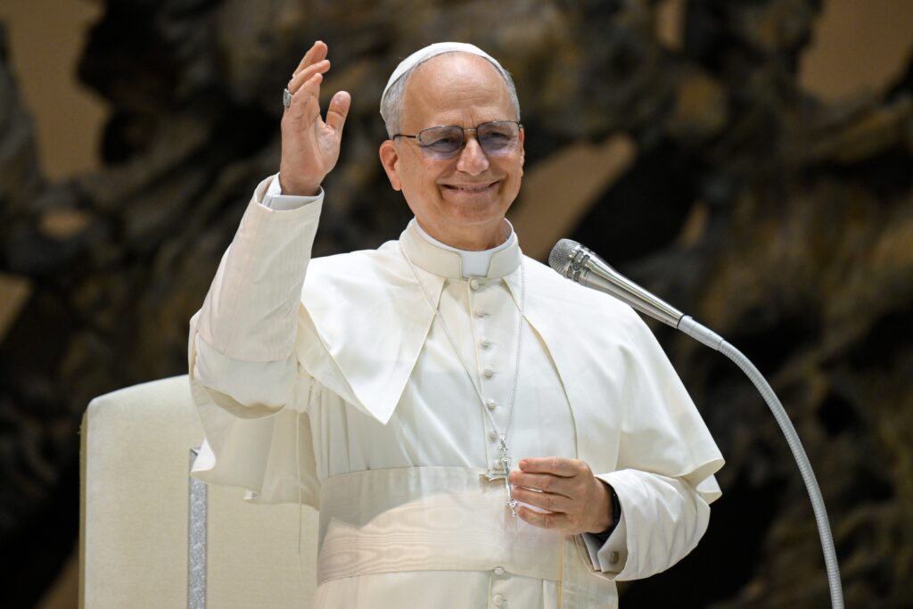 Pope Leo XIV waves during a meeting with officials and employees of the Roman Curia, Vatican City State and the Diocese of Rome in the Paul VI Audience Hall at the Vatican, May 24, 2025