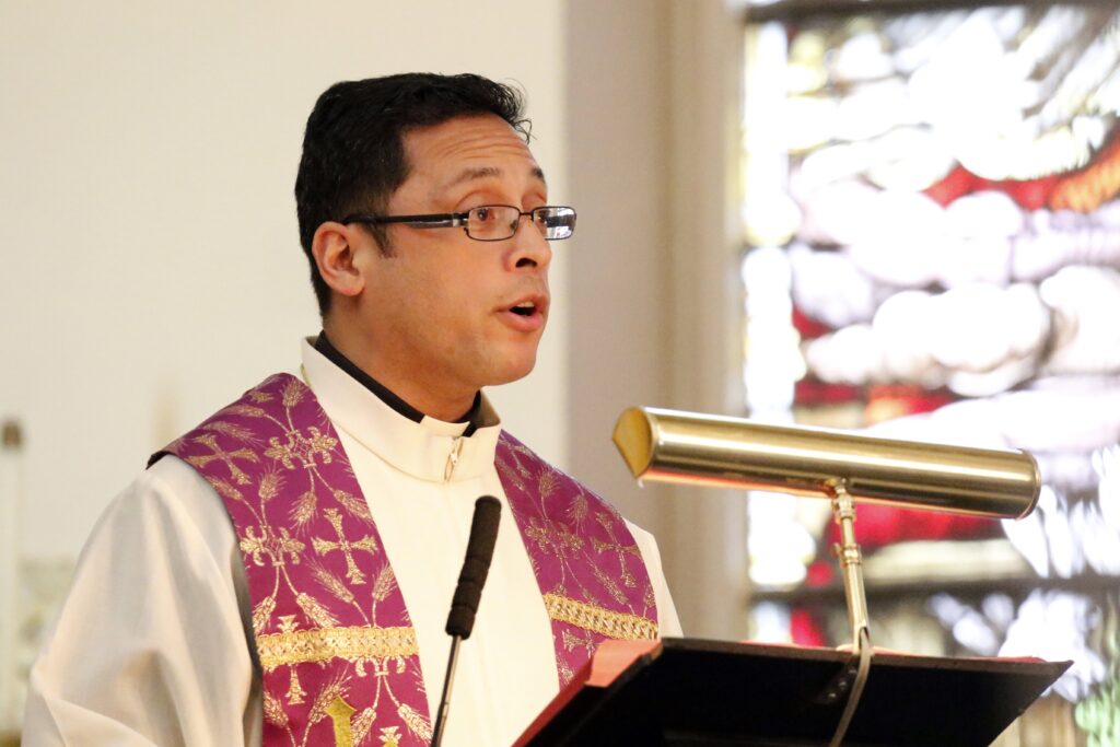 Father Pedro Bismarck Chau proclaims the Gospel during Ash Wednesday Mass March 1, 2017, at St. Patrick's Pro-Cathedral in Newark, New Jersey.
