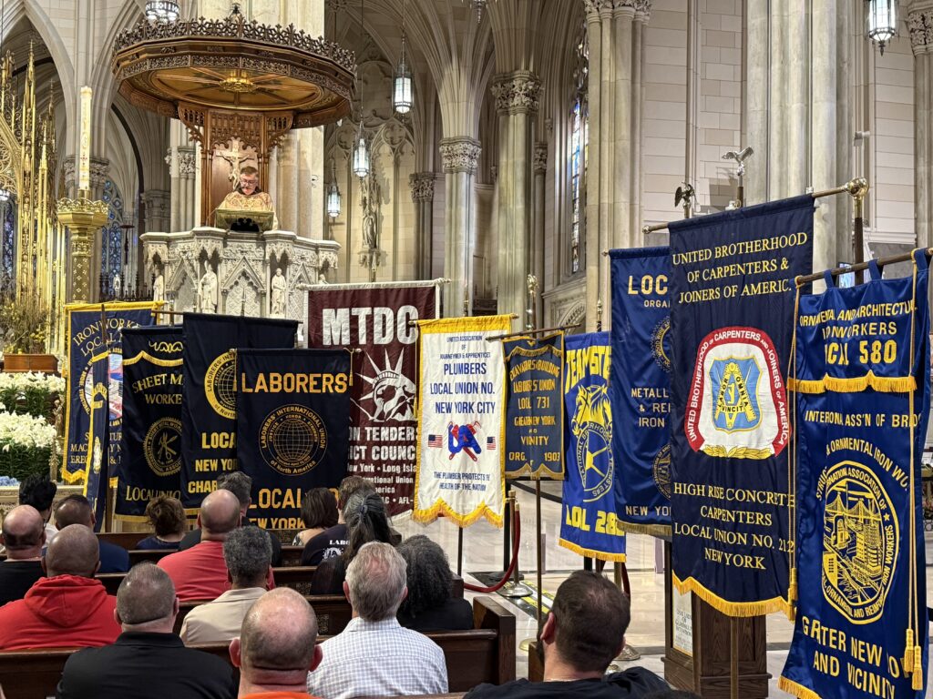 Father Brian Jordan offers his homily from the pulpit of St. Patrick’s Cathedral, with banners from local building and construction unions on display during the 17th annual Hard Hat Mass, held April 30, 2025, at St. Patrick’s Cathedral.