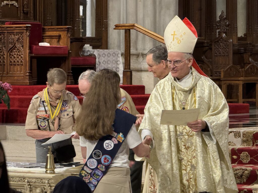 Archdiocese of New York Auxiliary Bishop Peter Byrne (center) presents a Catholic Scouting Emblem to a young scout on May 18, 2025, at St. Patrick’s Cathedral in Manhattan.