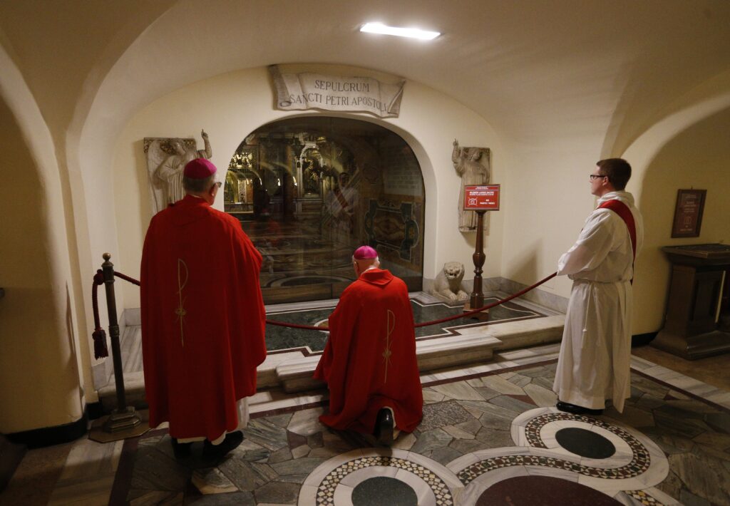 Bishop Daniel E. Thomas of Toledo, Ohio, kneels in prayer in front of the tomb of St. Peter after U.S. bishops from Ohio and Michigan concelebrated Mass in the crypt of St. Peter's Basilica at the Vatican December 9, 2019. (CNS photo/Paul Haring)