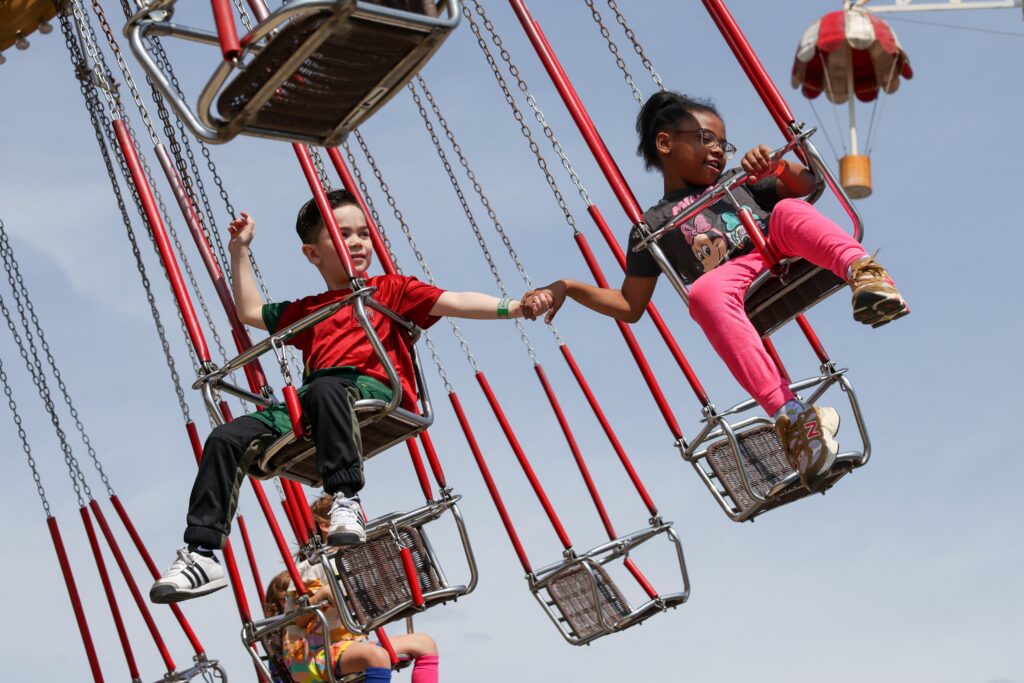 Children hold hands on a ride at Luna Park in Coney Island on opening day of the season in Brooklyn on March 29, 2025.