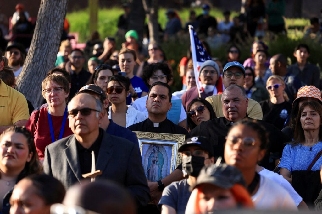 A member of the clergy holding an image of Our Lady of Guadalupe attends a vigil in Grand Park in downtown Los Angeles June 10, 2025, as protests against federal immigration sweeps continue. Photo: OSV News/David Swanson, Reuters.