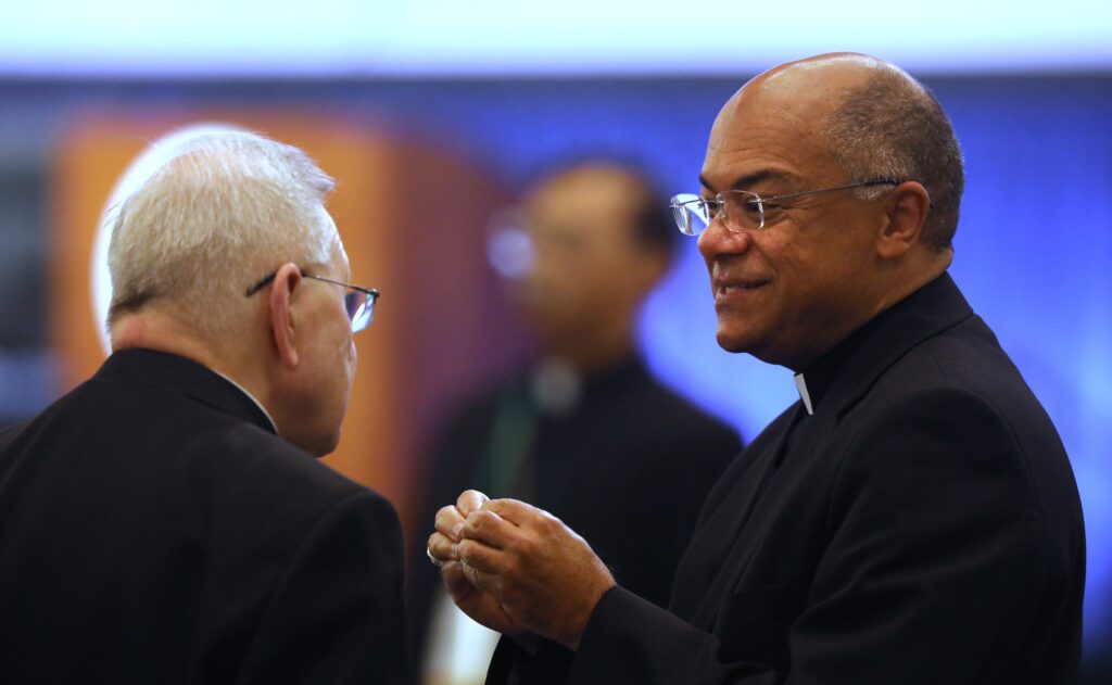 New Orleans Archbishop Gregory M. Aymond, and Archbishop Shelton J. Fabre of Louisville, Kentucky, speaks during a break at a November 15, 2023, session of the fall general assembly of the U.S. Conference of Catholic Bishops in Baltimore.