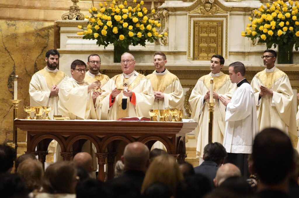 Cardinal Timothy M. Dolan celebrates a Mass during which he ordained Jesuit Fathers Kieran Halloran, back left, Douglas Jones, Joseph Lorenz, Jonathan Pennacchia and Melvin Rayappa to the priesthood at St. Ignatius Loyola Church in New York City June 14, 2025.