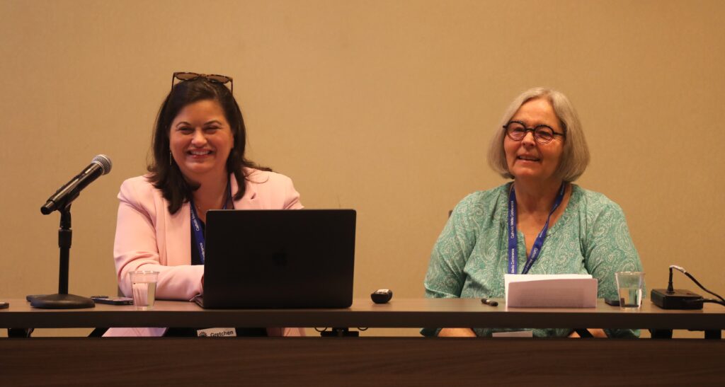 Gretchen R. Crowe, editor in chief of OSV News and outgoing president of the Catholic Media Association, and Cindy Wooden, Catholic News Service Rome editor in chief, smile during a June 27, 2025, session of the Catholic Media Conference in Phoenix.