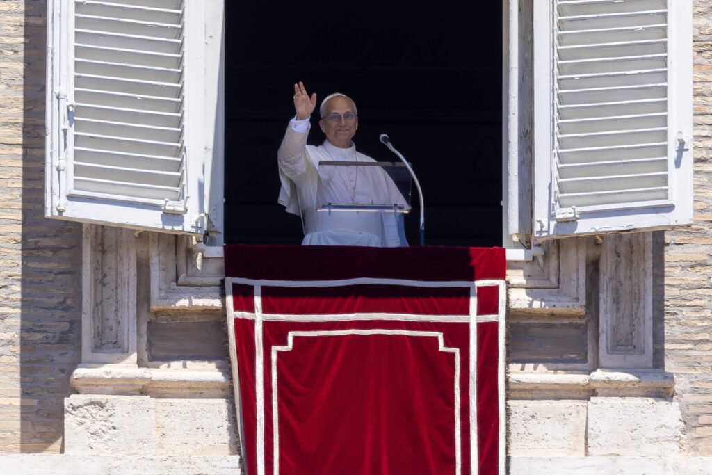 Pope Leo XIV waves to the crowd in St. Peter's Square at the Vatican as they join him for the recitation of the Angelus prayer on June 29, 2025.