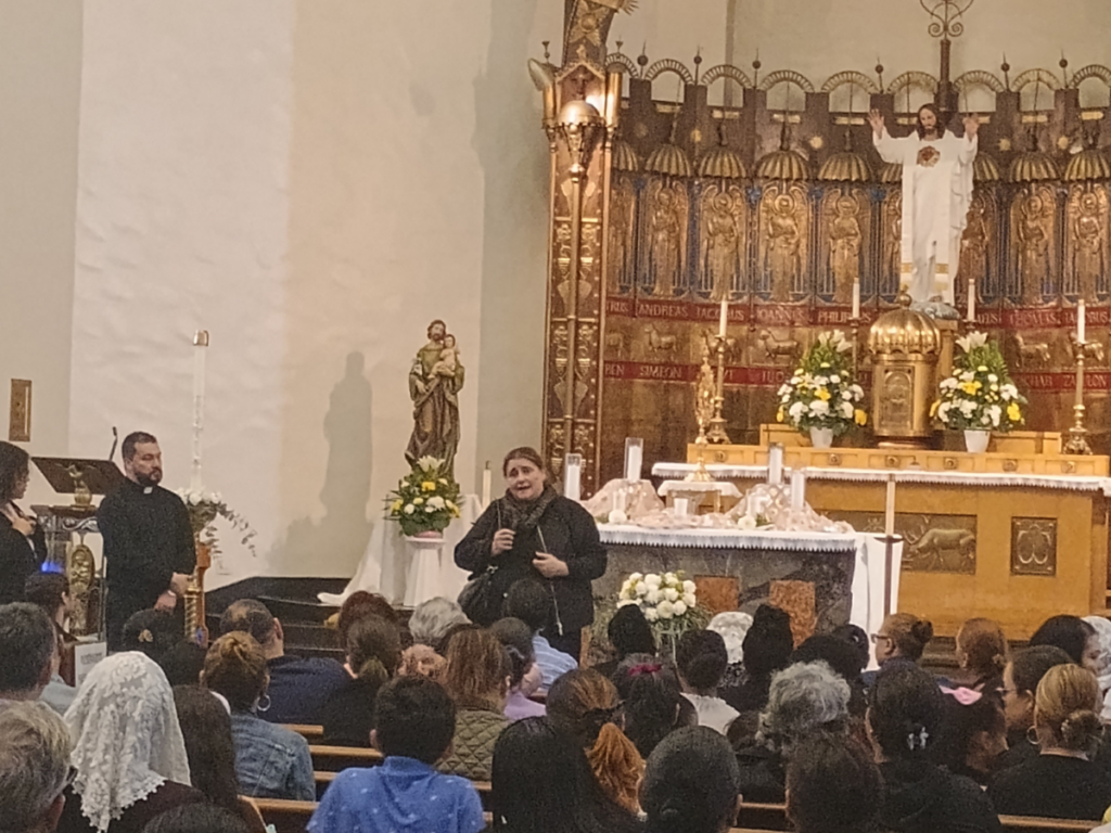 Antonia Salzano during her May 30, 2025, talk at St. Anthony of Padua Church in the Bronx. At the left is Father Fredy Patiño, parish administrator. Photo by Armando Machado/The Good Newsroom.
