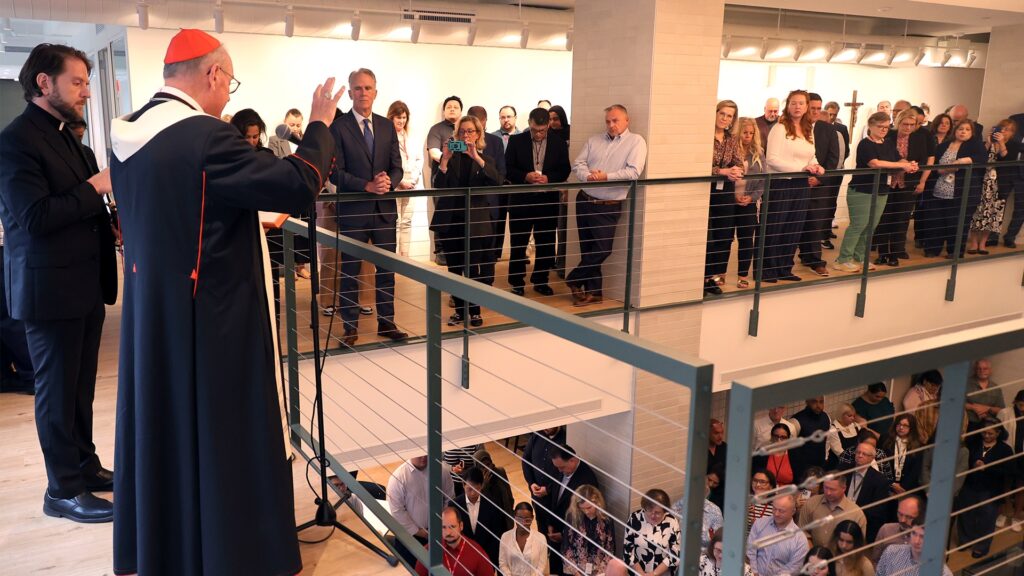 Cardinal Timothy Dolan, (second left) blesses the staff and new premises of the Archdiocese of New York, at 488 Madison Avenue in Manhattan, on June 9, 2025.