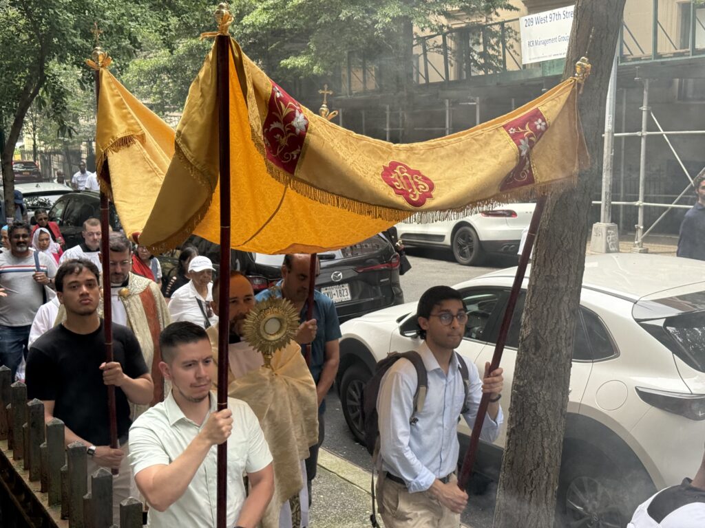 Father George Sears (center, under canopy) carries the monstrance bearing the Blessed Sacrament during the 2025 Upper West Side Corpus Christi procession on Sunday, June 22, 2025.