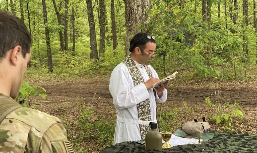 Father Peter Pomposello celebrates a field Mass for soldiers of the 101st Airborne Division at Fort Campbell, Kentucky, in the summer of 2022.