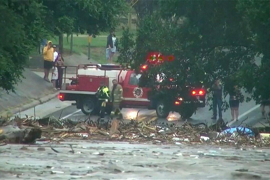 First responders survey rising flood waters of the Guadalupe River after flash flooding in Kerr County, Texas, on July 4, 2025.