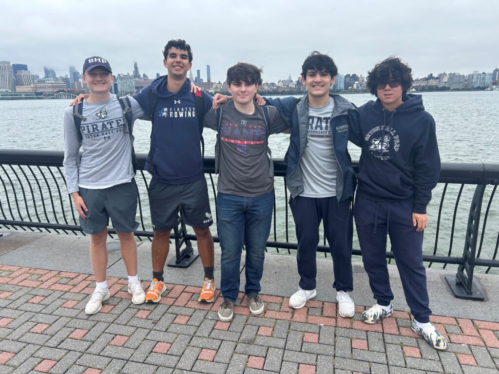 Max Widmer, second from left, and other members of Seton Hall Preparatory School's Veterans Service Club participate in "Ruck the River" pose at the waterfront in Hoboken, New Jersey, in this undated photo.