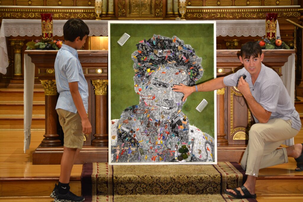 Denver-based multimedia artist Johnny Vrba is pictured inside the St. Hedwig church building of Blessed Carlo Acutis Parish on Chicago's northwest side July 23, 2025.