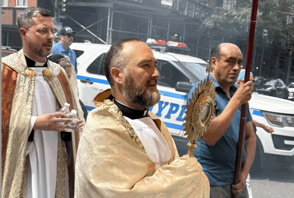 Father George Sears (holding monstrance) carries the Blessed Sacrament during the Upper West Side Eucharistic Procession on Corpus Christi, Sunday, June 30, 2025.
