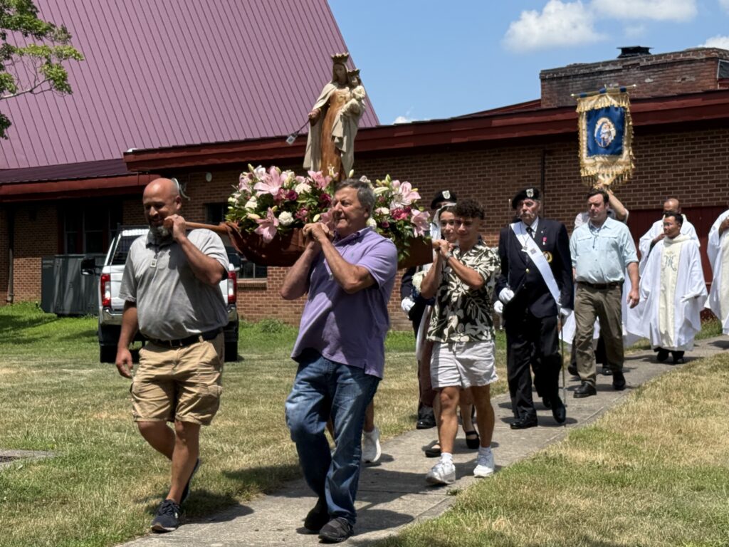 Pilgrims carry a statue of Our Lady of Mount Carmel on her feast day, July 16, 2025, in Middletown.