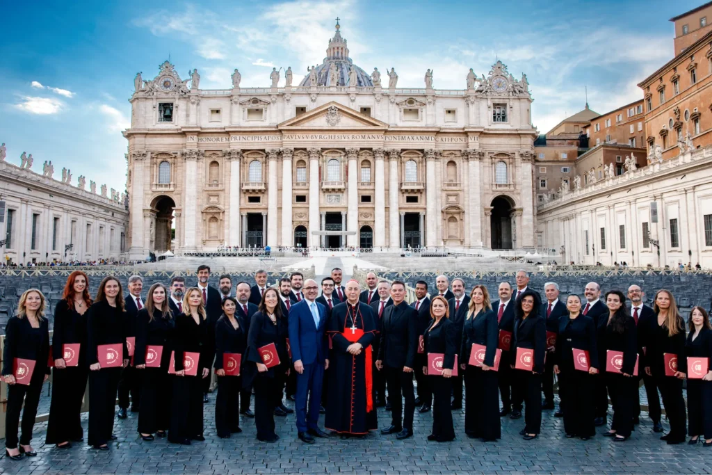 Members of the Sacred Voices Choir in front of St. Peter’s Basilica with Cardinal Dominique Mamberti, Honorary President of the Cardinal Bartolucci Foundation, September 2024. Photo courtesy of the Cardinal Bartolucci Foundation