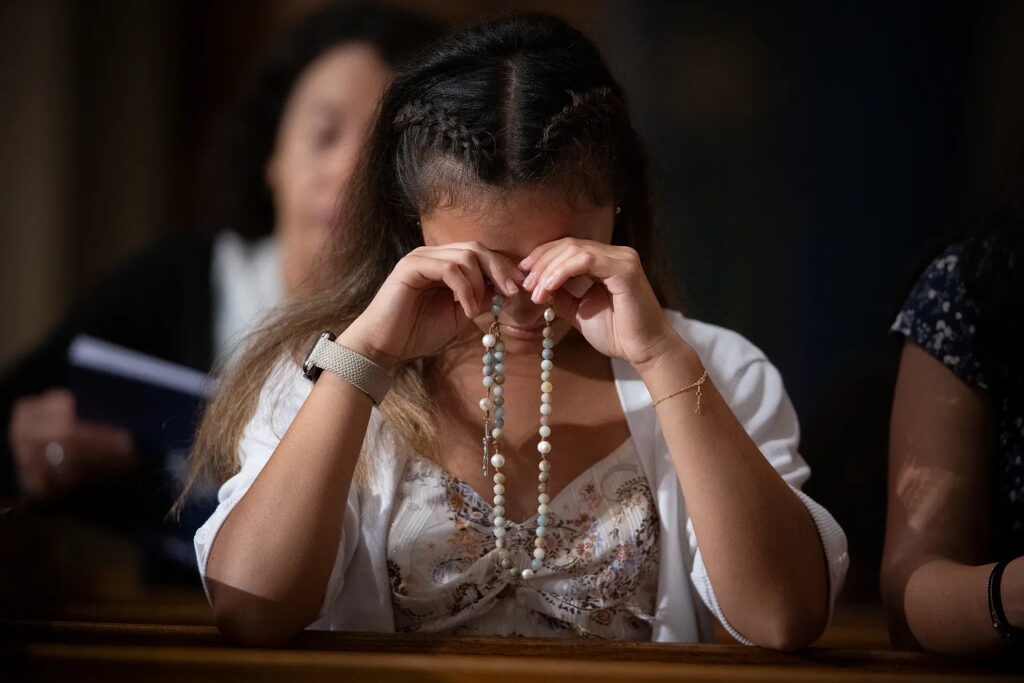 A young woman prays in this undated photo.
