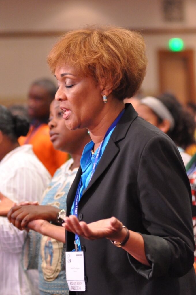 Valerie Washington, executive director of the National Black Catholic Congress organization, prays during a conference Mass on July 20 in Indianapolis.