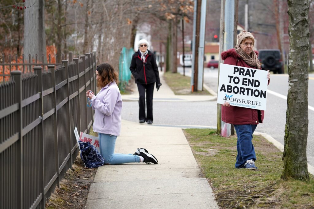 Pro-life advocates participate in a 40 Days for Life vigil near the entrance to a Planned Parenthood center in Smithtown, March 19, 2020.