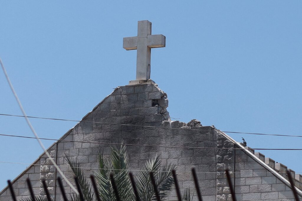 Burn marks can be seen below a cross atop Holy Family Church in Gaza City, July 18, 2025, which was hit in an Israeli strike the previous day.