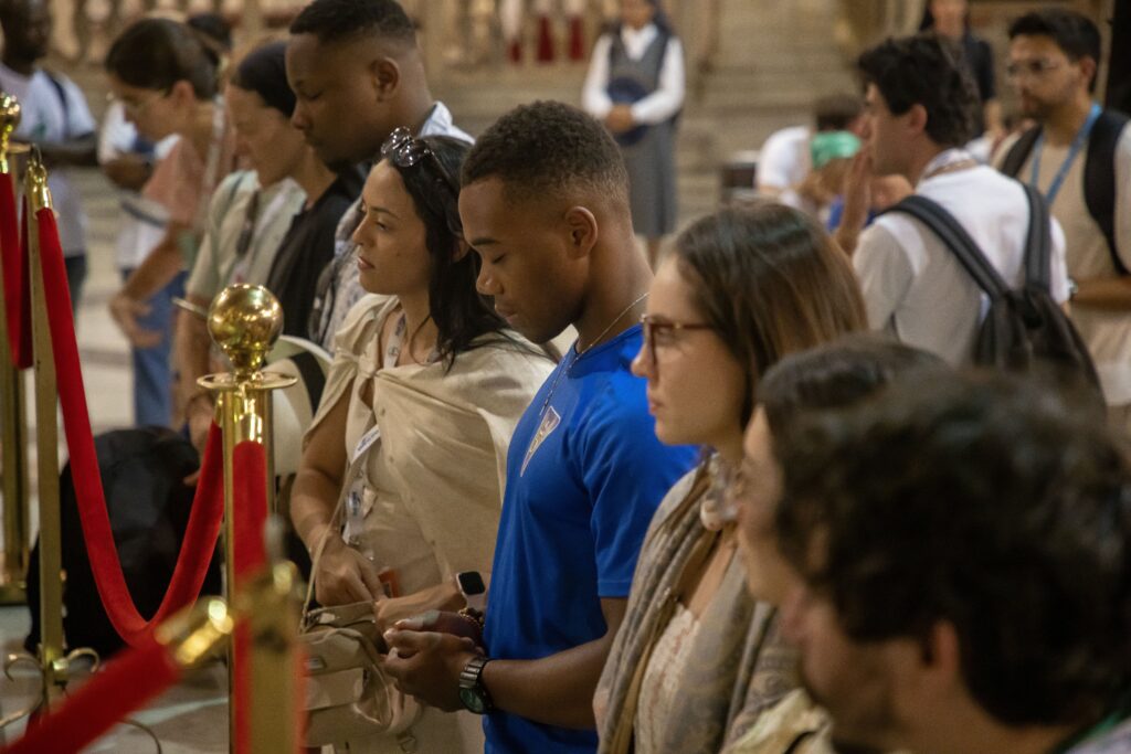 Pilgrims pray before the casket of Blessed Pier Giorgio Frassati at the Basilica of Santa Maria sopra Minerva in Rome on July 31, 2025.