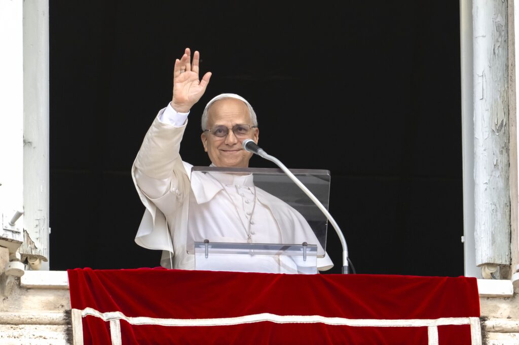 Pope Leo XIV waves after leading the recitation of the Angelus prayer with visitors gathered in St. Peter's Square at the Vatican, August 24, 2025.