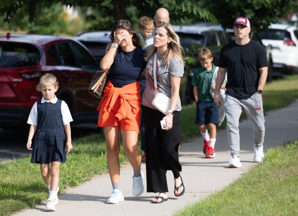 Families and loved reunite following a shooting at Annunciation Catholic School in Minneapolis August 27, 2025.