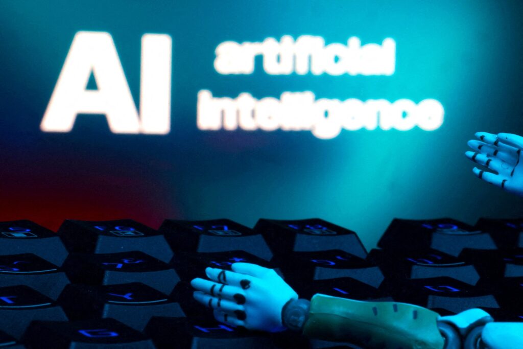 A message reading "AI artificial intelligence," a keyboard and robot hands are seen in this illustration created on January 27, 2025.