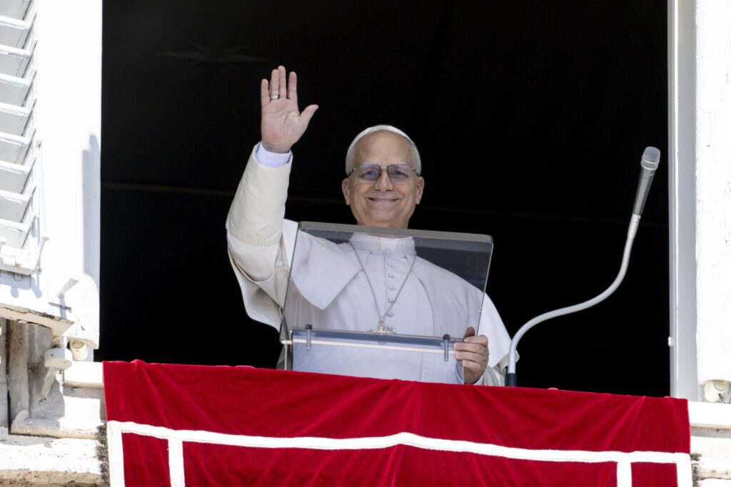 Pope Leo XIV waves to visitors and pilgrims in St. Peter's Square at the Vatican on August 31, 2025, before leading the recitation of the Angelus prayer.