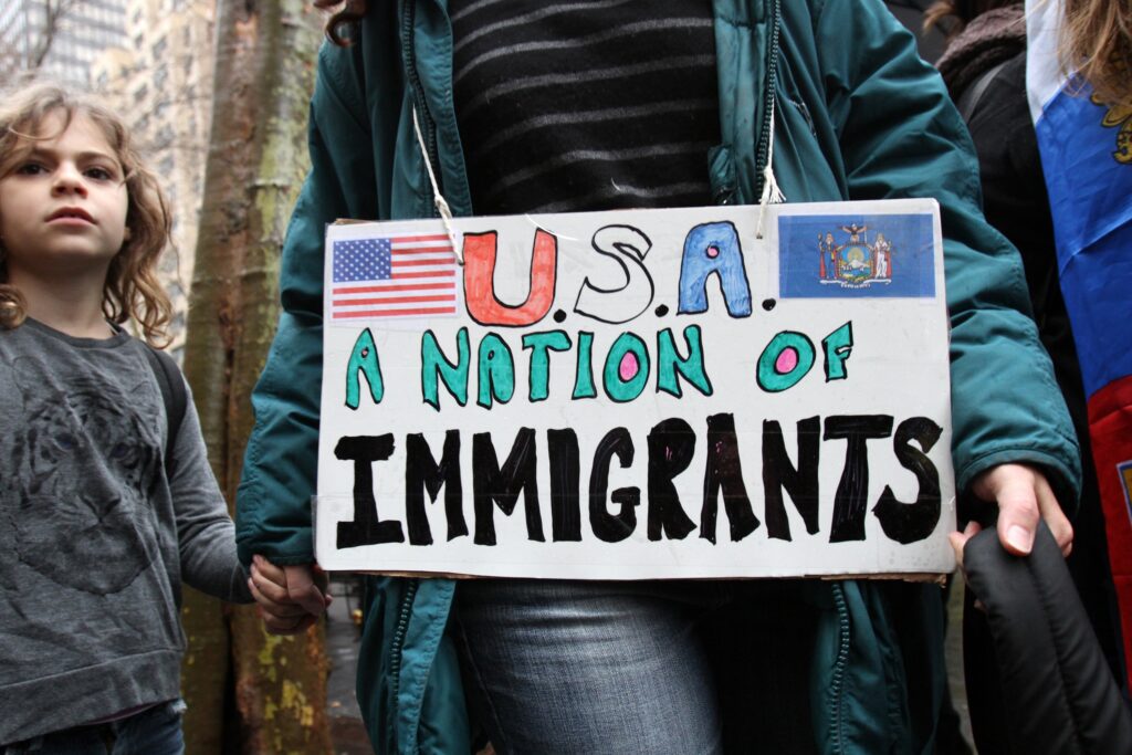 A woman holds a child's hand as they arrive for a rally in support of immigrants' rights on December 18, 2016, in Manhattan.