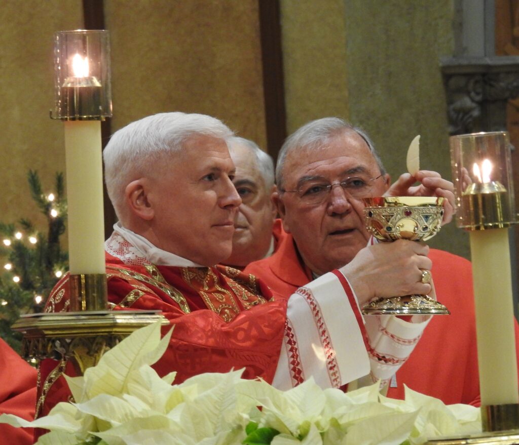 Bishop Daniel E. Thomas (left, holding chalice) of Toledo, Ohio, celebrates Mass December 28, 2016 at the Cathedral of St. John the Evangelist in Cleveland.