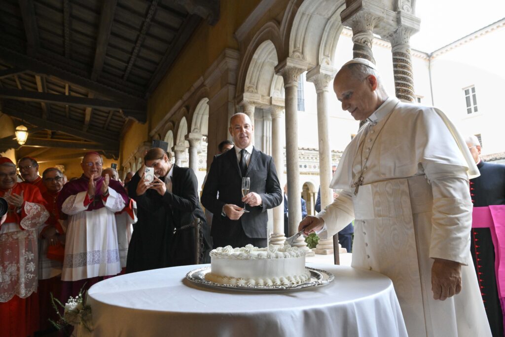 Pope Leo XIV slices a cake for his 70th birthday, September 14, 2025, as cardinals, Vatican officials and ecumenical leaders look on after a prayer service at Rome's Basilica of St. Paul Outside the Walls.