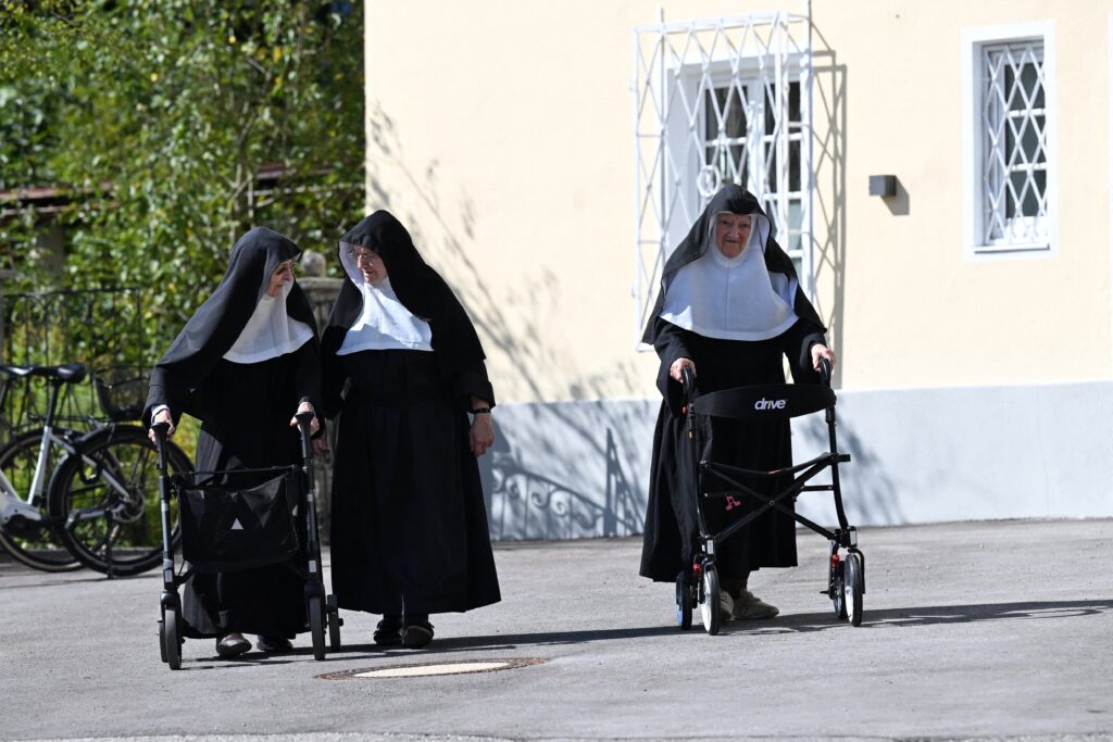 Augustinian Sisters Regina, 86, Rita, 81, and Bernadette, 88, walk, as they occupy their old convent in Goldenstein castle in Elsbethen, Austria, on September 12, 2025, near Salzburg, and refuse to move back to their retirement home.