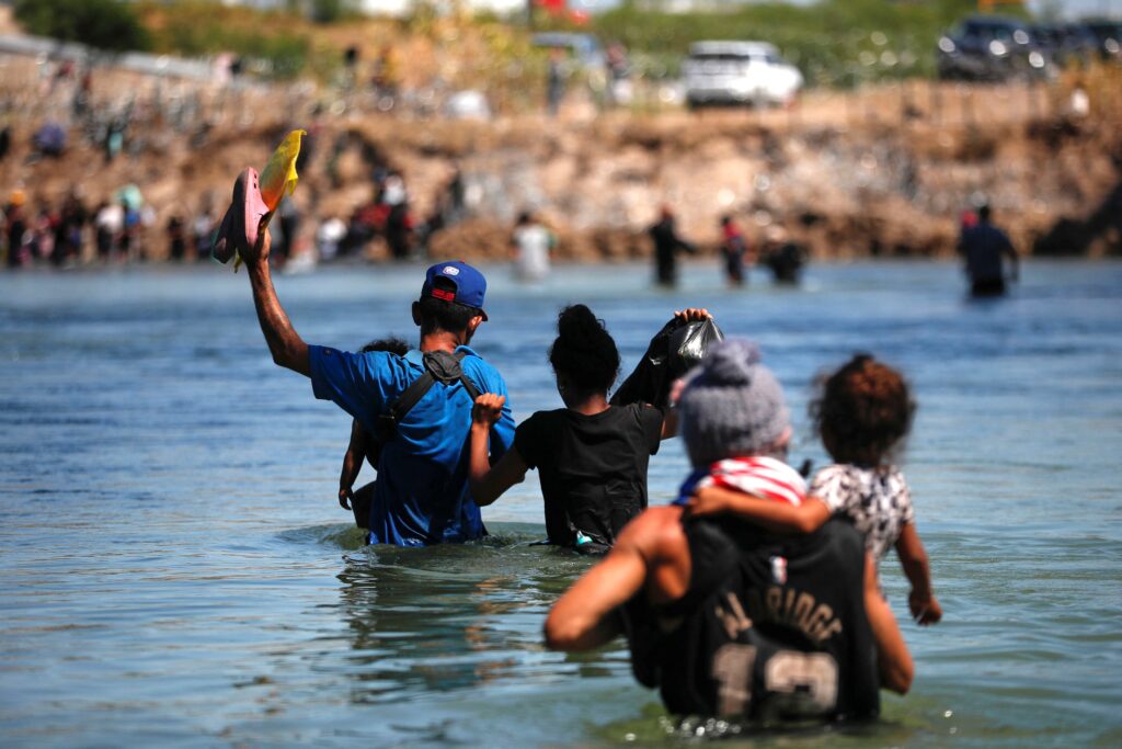 A group of migrants crosses the Rio Grande to try to seek asylum in the U.S., as seen from Piedras Negras, Mexico, on September 28, 2023.