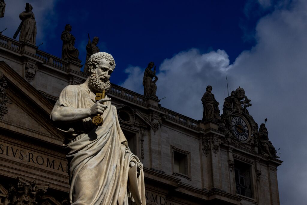 The sun lights up the statue of St. Peter in St. Peter's Square at the Vatican on a stormy Sept. 24, 2025, before Pope Leo XIV leads his weekly general audience.