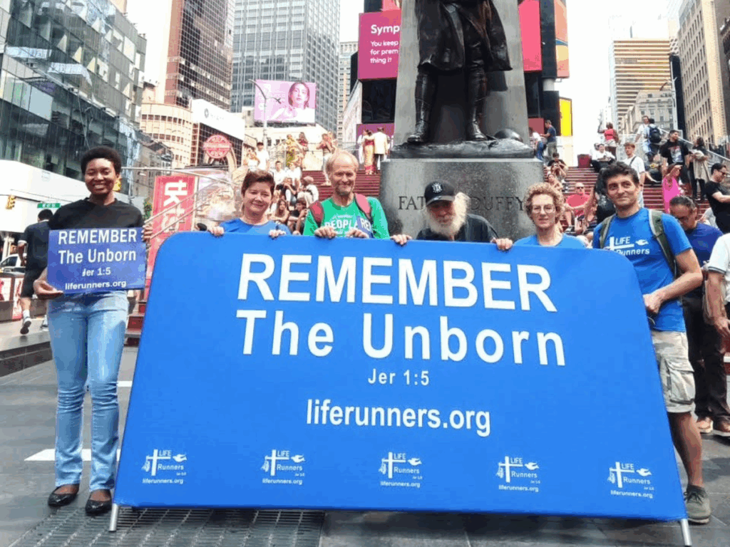 Participants in the annual A-Cross America Relay for Pro-Life stop in Father Duffy Square, Manhattan, on September 6, 2025.