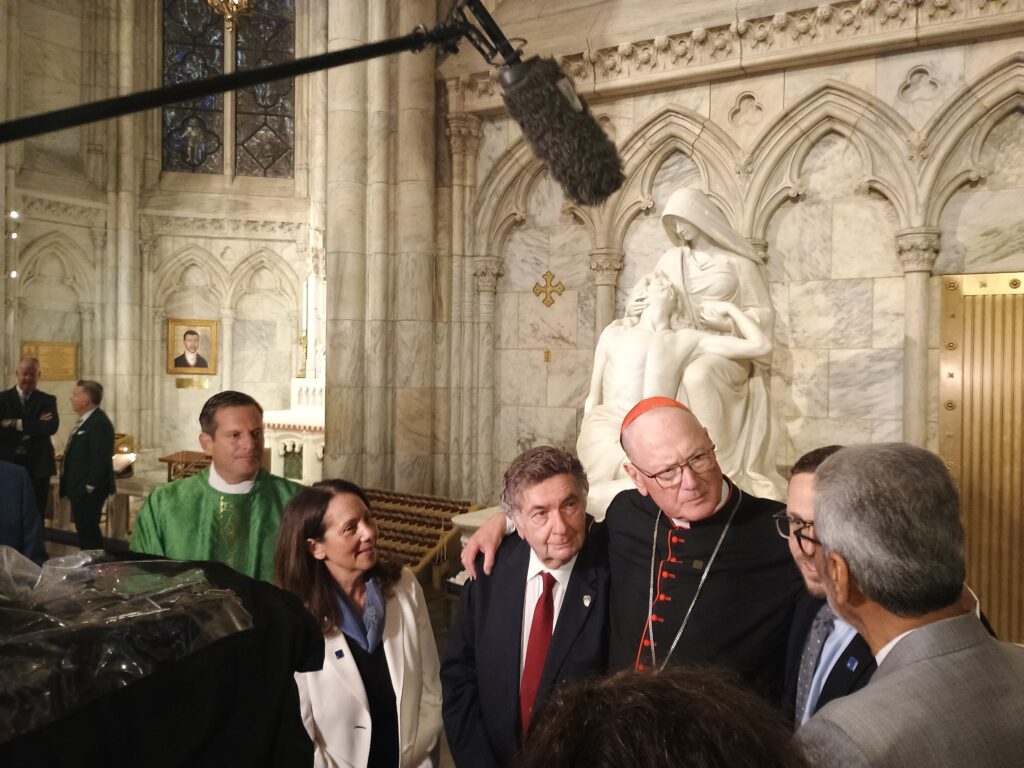 Cardinal Timothy Dolan (center) speaks with reporters after Mass at St. Patrick's Cathedral on Sunday, September 7, 2025, along with Karen Dresbach, executive vice president of the Appeal of Conscience Foundation (second left) and Rabbi Joseph Potasnik, executive vice president of The New York Board of Rabbis (center left).