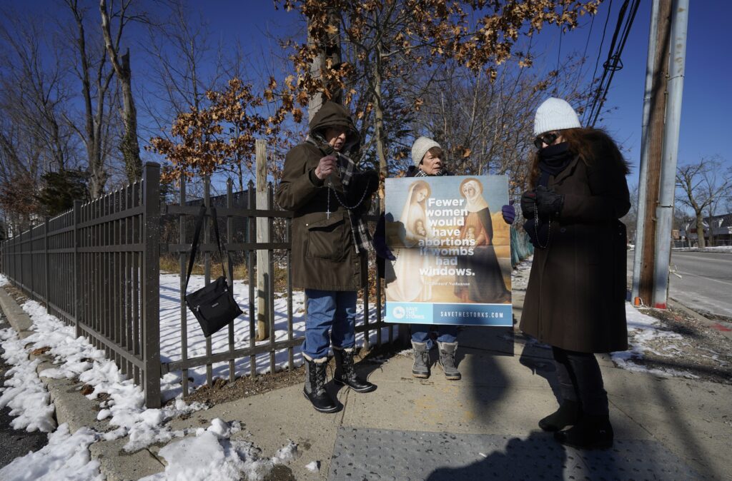 Pro-life advocates Geraldine Graham, left, Betsy Carey and Linda Lyon brave the 18-degree temperature as they recite the rosary near the entrance to a Planned Parenthood center in Smithtown, on January 22, 2025, the Day of Prayer for the Legal Protection of Unborn Children.