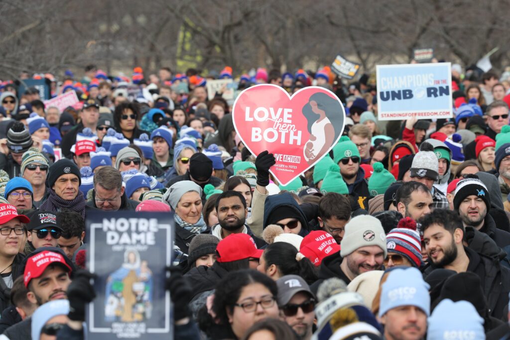 People hold signs during the 52nd annual March for Life rally in Washington, January 24, 2025.
