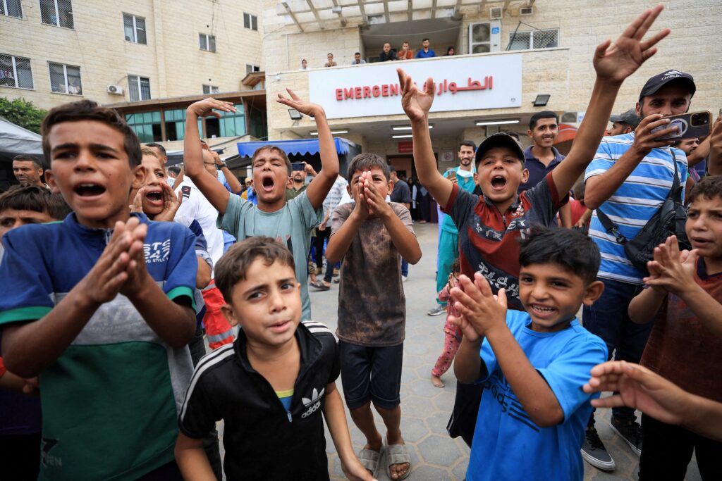 Palestinian children celebrate in Khan Younis in the southern Gaza Strip after U.S. President Donald Trump announced that Israel and Hamas agreed on the first phase of a Gaza ceasefire October 9, 2025. Photo: OSV News/Dawoud Abu Alkas, Reuters