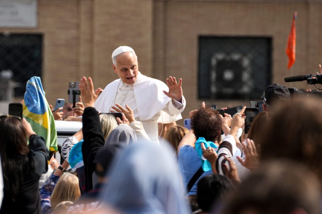 Pope Leo XIV greets people from the popemobile as he rides around St. Peter’s Square after celebrating Mass at the Vatican on October 12, 2025, as part of the Jubilee of Marian Spirituality.