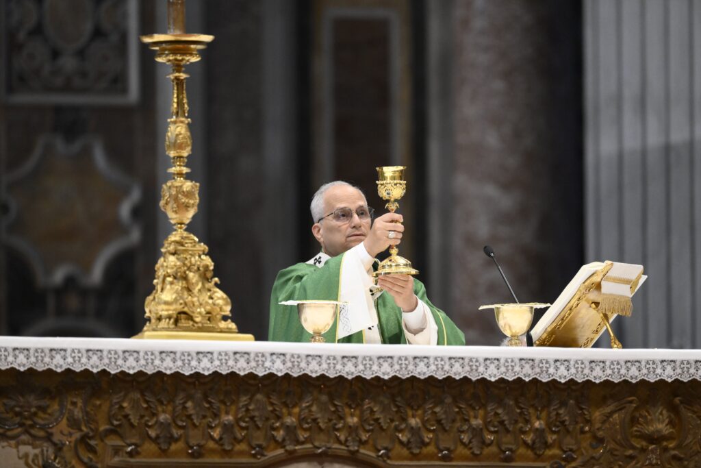 Pope Leo XIV elevates the chalice as he celebrates Mass as part of the Jubilee of Synodal Teams and Participatory Bodies in St. Peter's Basilica at the Vatican on October 26, 2025.