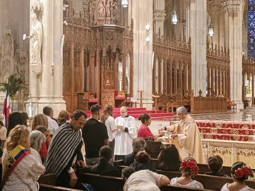 Father Jose Felix Ortega administers communion during the Hispanic Day Mass at St. Patrick’s Cathedral, Sunday, October 5, 2025. Photo by: Armando Machado/The Good Newsroom